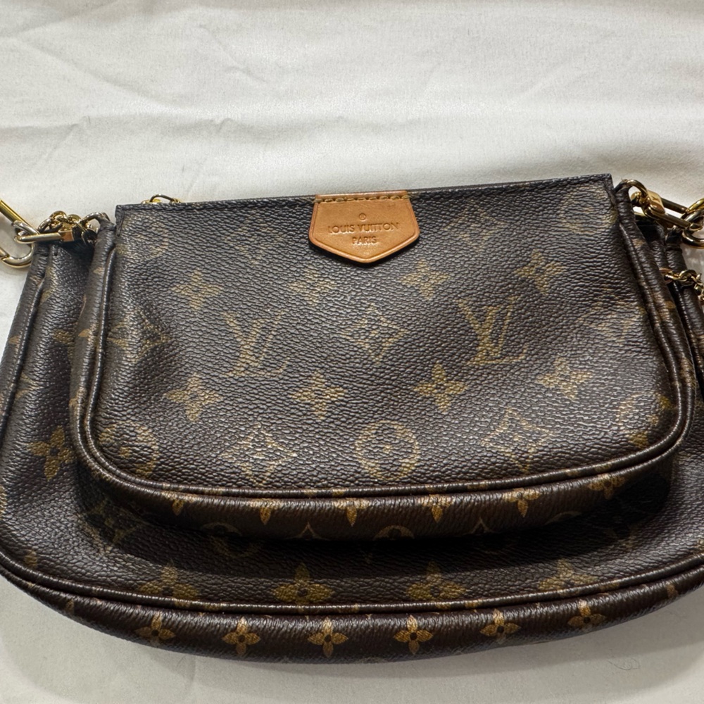 Louis Vuitton Mini Pochette with coin purse and pink strap.